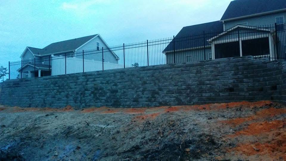 Iron ornamental fence on retaining wall by MBK Fencing