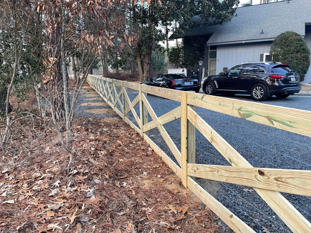 Split rail fence with wire mesh by MBK Fencing