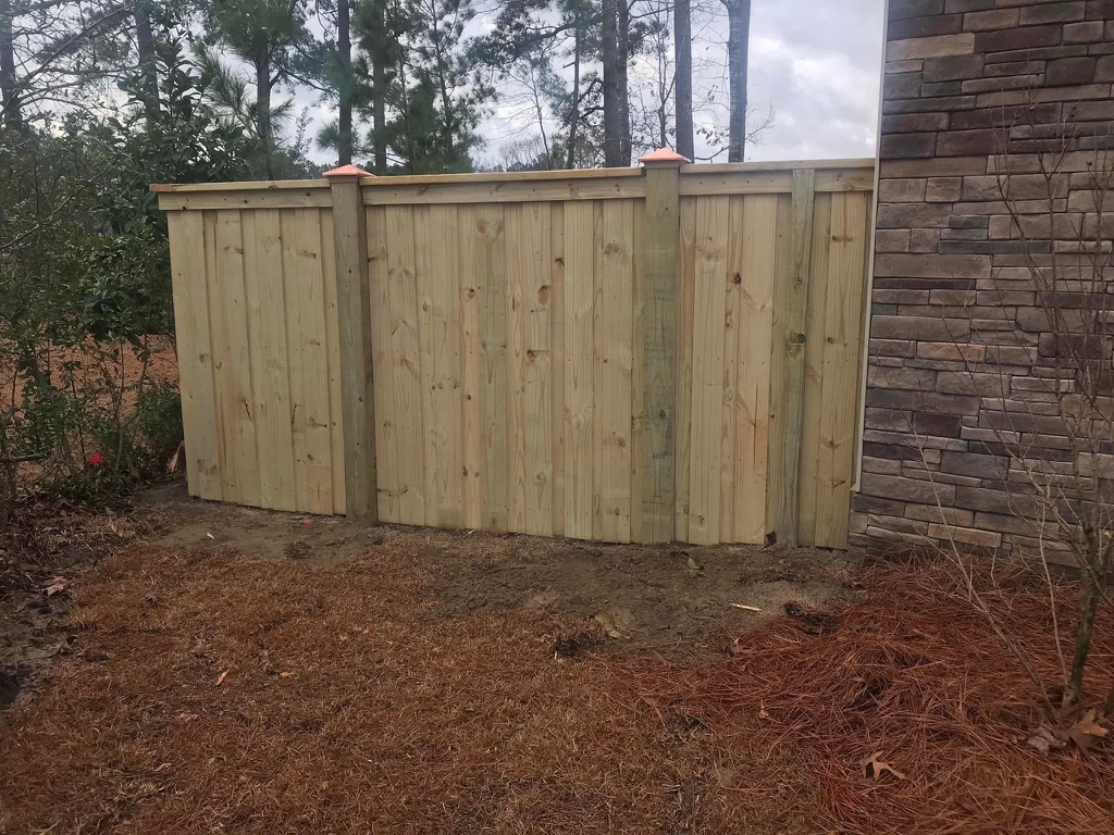 Wood privacy fence with copper caps by MBK Fencing