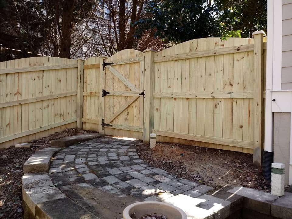 Wood fence with arched gate by MBK Fencing