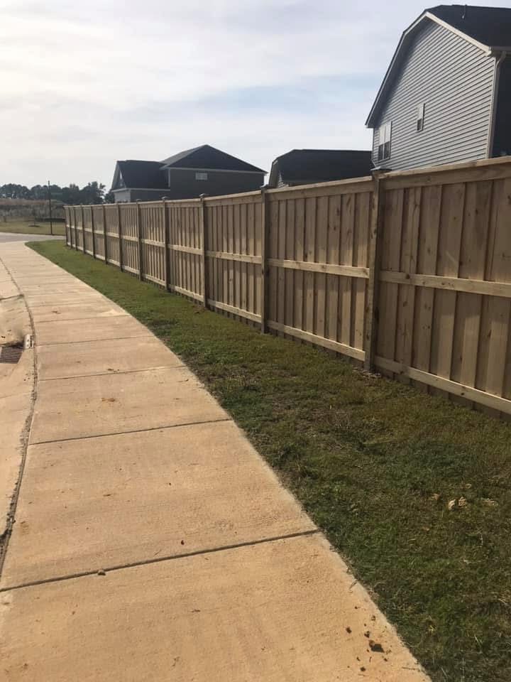 Wood privacy fence along sidewalk by MBK Fencing